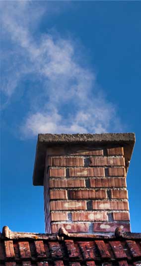 Let Us Clean Your Chimney! Smoke Coming Out of a Chimney